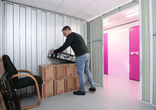 Image of a man in a storage unit organising items
