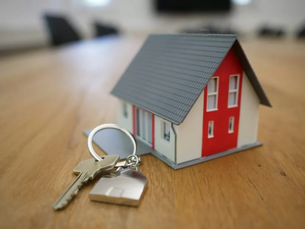 Miniature House model with keys next to it.
