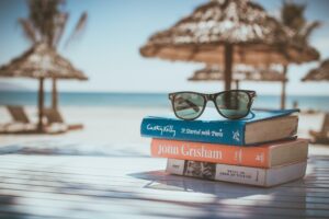 Books And Sunglasses On Beach