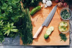 Chopping board with herbs and other cooking ingredients